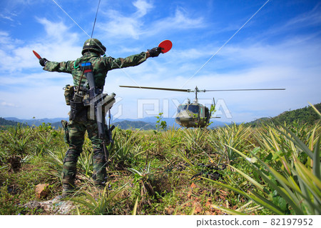 Soldier gives signal to helicopter 82197952