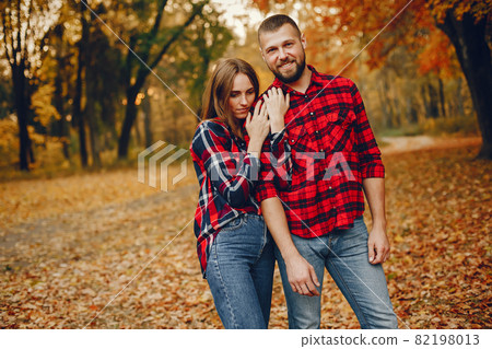 Elegant couple spend time in a autumn park Elegant couple spend time in a autumn park 82198013