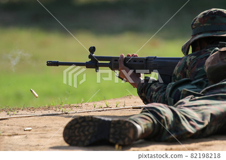 Soldier firing rifle gun to target Soldier firing rifle gun to target 82198218