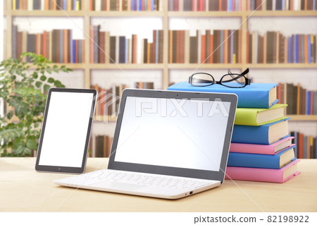 Laptops and tablets with a bookshelf in the background Laptops and tablets with a bookshelf in the background 82198922