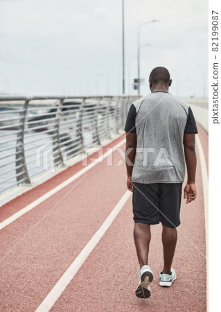 Sportsman walking along the stadium 82199087