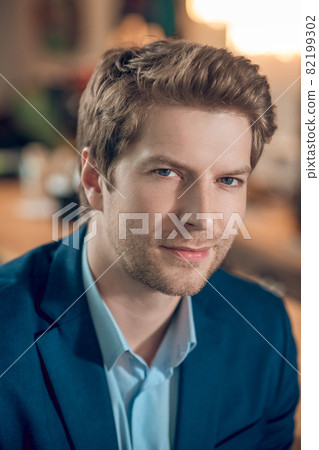 Young adult man in blue jacket 82199302