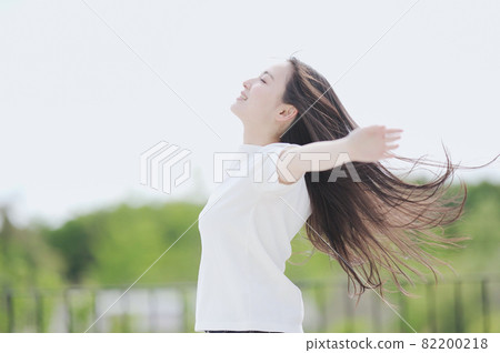 A woman with her hair fluttering outdoors 82200218