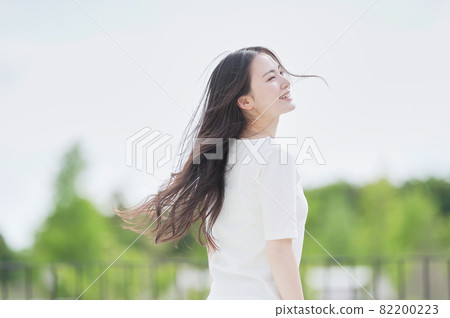 A woman with her hair fluttering outdoors 82200223