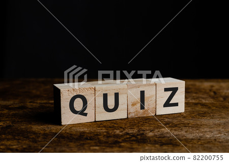 Wooden block cube with alphabet text "QUIZ" on wood table. message education knowledge symbol. Wooden block cube with alphabet text "QUIZ" on wood table. message education knowledge symbol. 82200755