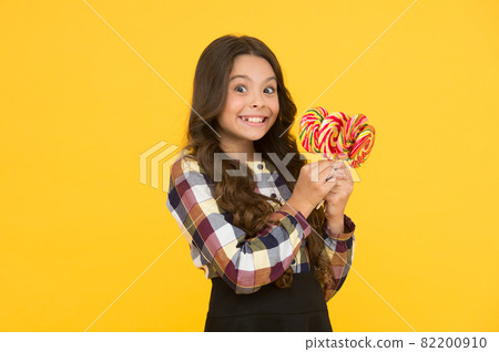 She has sweet tooth. Little girl enjoy delicious taste  82200910