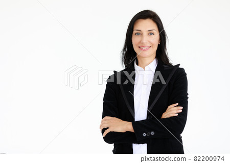 Portrait of beautiful woman in black suit standing in front of white background 82200974