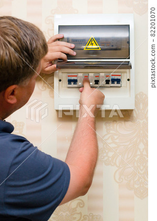 A man has opened an electric shield with switches, is looking for a malfunction 82201070