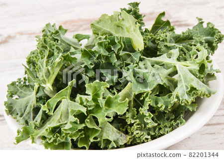 Fresh healthy green curly kale, diet, slimming and healthy eating concept Fresh healthy green curly kale, diet, slimming and healthy eating concept 82201344
