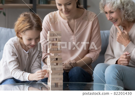 Happy family playing wooden boardgame at home. Happy family playing wooden boardgame at home. 82201430