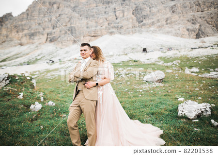 Sunshine portrait of happy bride and groom outdoor in nature location 82201538
