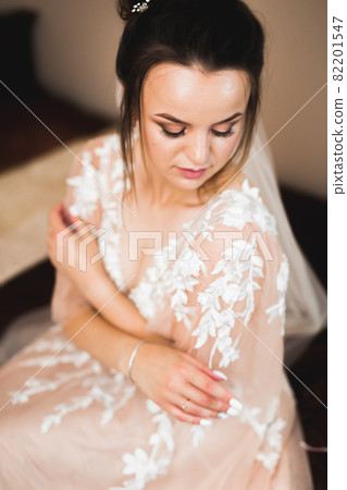 Grooms morning preparation. Handsome man getting dressed and preparing for the wedding 82201547