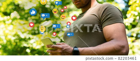 Unrecognizable young afro american confident muscular man, surfing in internet, chatting in social networks 82203461