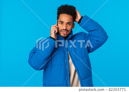 Problems, mobile addiction and lifestyle concept. Confused and tensed indecisive young african american man dont know what say, talking on phone, use smartphone, scratching head unsure 82203771