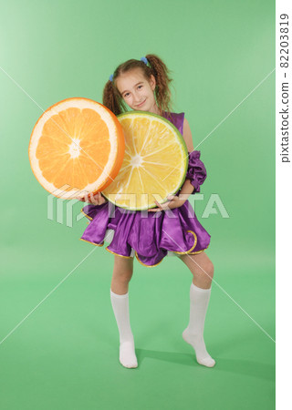 Pretty girl posing for the camera, in a violet short dress. Pretty girl posing for the camera, in a violet short dress. 82203819