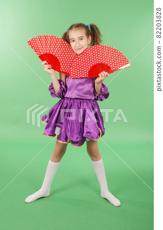 Pretty girl posing for the camera, in a violet short dress. Pretty girl posing for the camera, in a violet short dress. 82203828
