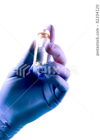 Vaccination from coronavirus Covid-19 concept with doctor's hands wearin protective gloves, holding botle of liquid medication. Vaccination from coronavirus Covid-19 concept with doctor's hands wearin protective gloves, holding botle of liquid medication. 82204120