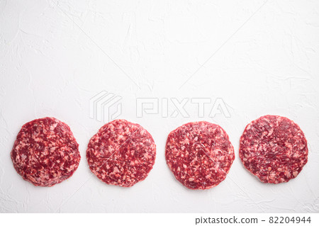 Raw Minced Steak Burgers from Beef Meat, on white stone background, top view flat lay, with copy space for text Raw Minced Steak Burgers from Beef Meat, on white stone background, top view flat lay, with copy space for text 82204944