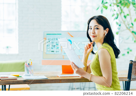 Business woman looking at documents in the office Business woman looking at documents in the office 82206214