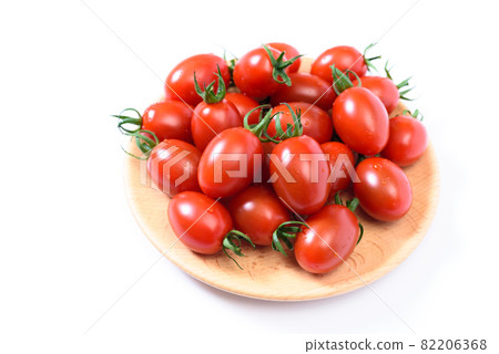 Aiko serving beautiful washed cherry tomatoes on a wooden plate Aiko serving beautiful washed cherry tomatoes on a wooden plate 82206368