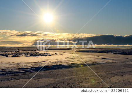 Arctic landscape in winter time. Small river with ice in tundra. 82206551
