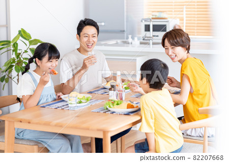 Family of four eating in the dining room 82207668