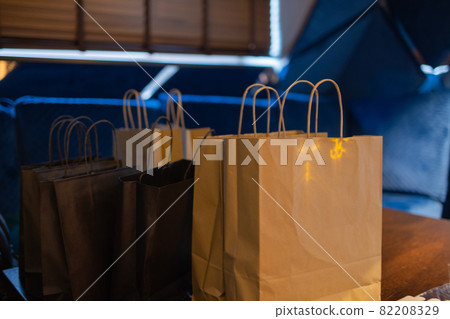 Courier delivery food service at home. Woman courier delivered the order no name bag with food. Courier delivery food service at home. Woman courier delivered the order no name bag with food. 82208329