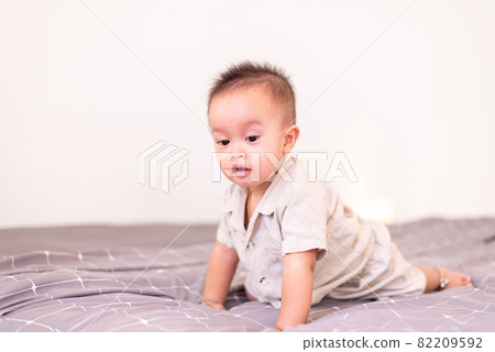 Adorable asian baby boy crawl on bed,Happy and fun new born kid 82209592