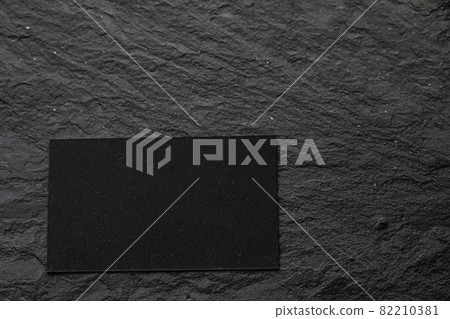 Blank black card on stone as flatlay background Blank black card on stone as flatlay background 82210381
