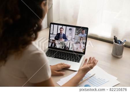 Woman sit at desk at home participate in business videoconference 82210876