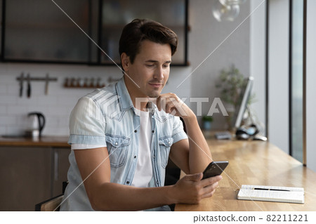 Young Caucasian man use cellphone browsing internet 82211221