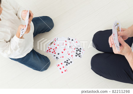 Grandmother and children playing cards 82211298