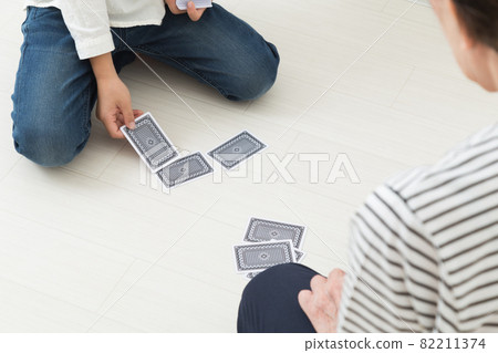 Grandmother and grandchild playing cards 82211374