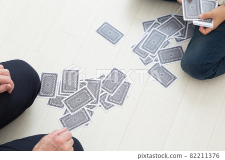 Seniors and children playing cards 82211376