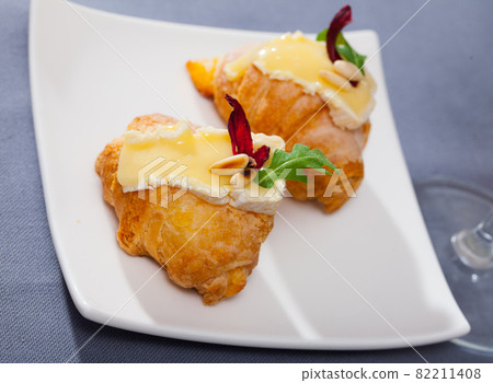 Camembert cheese on a mini croissant, french dessert at plate 82211408