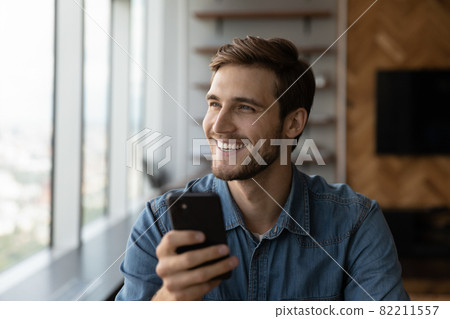 Excited young Caucasian man client use modern smartphone 82211557