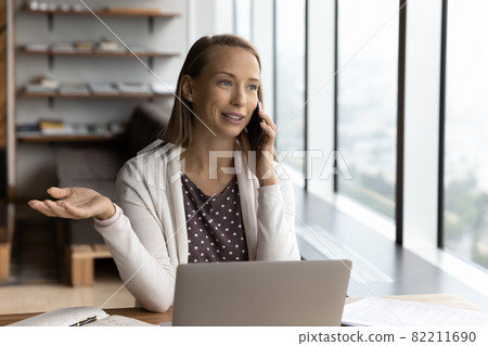 Young Caucasian businesswoman talk with client on smartphone 82211690