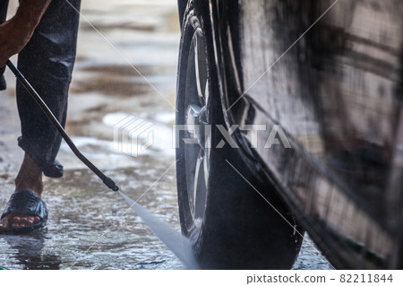 Car washing. Cleaning car with high pressure water and foam 82211844