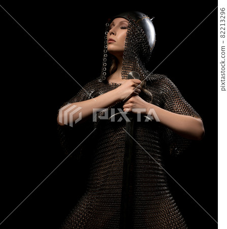 Sexy girl in viking helmet and hauberg with sword Sexy girl in viking helmet and hauberg with sword 82213296