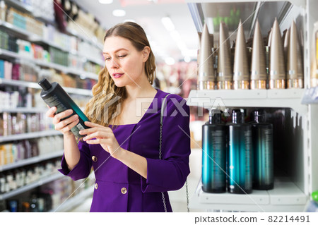 Woman choosing hair care cosmetics in store Woman choosing hair care cosmetics in store 82214491