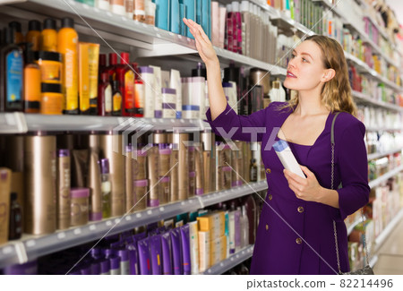 girl choosing hair care treatments girl choosing hair care treatments 82214496