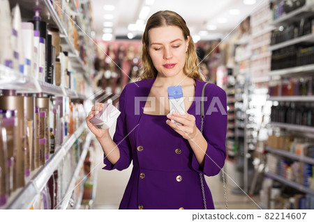 girl selecting hair care treatments girl selecting hair care treatments 82214607