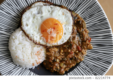 Keema curry topped with a fried egg, made at home from spices Keema curry topped with a fried egg, made at home from spices 82214774