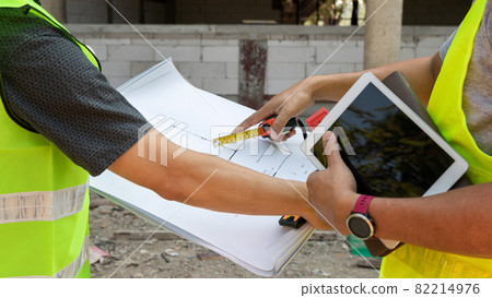 Engineer discussing with foreman about project in building construction site. Engineer discussing with foreman about project in building construction site. 82214976
