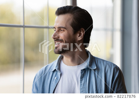 Head shot smiling dreamy man looking in distance, dreaming Head shot smiling dreamy man looking in distance, dreaming 82217876