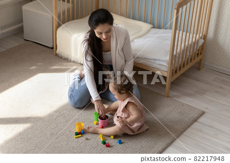 Happy loving mom and sweet toddler baby playing learning games Happy loving mom and sweet toddler baby playing learning games 82217948