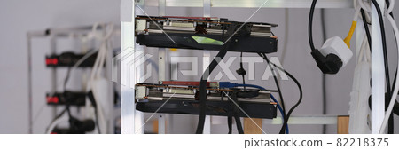 Many video cards are assembled into mining farm for cryptocurrency closeup 82218375