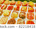 Countless Belgian waffles with various toppings 82218418