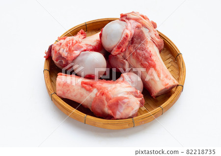 Raw pork bones in bamboo basket on white background. 82218735