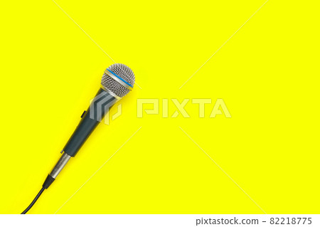 Microphone on yellow background. Top view 82218775